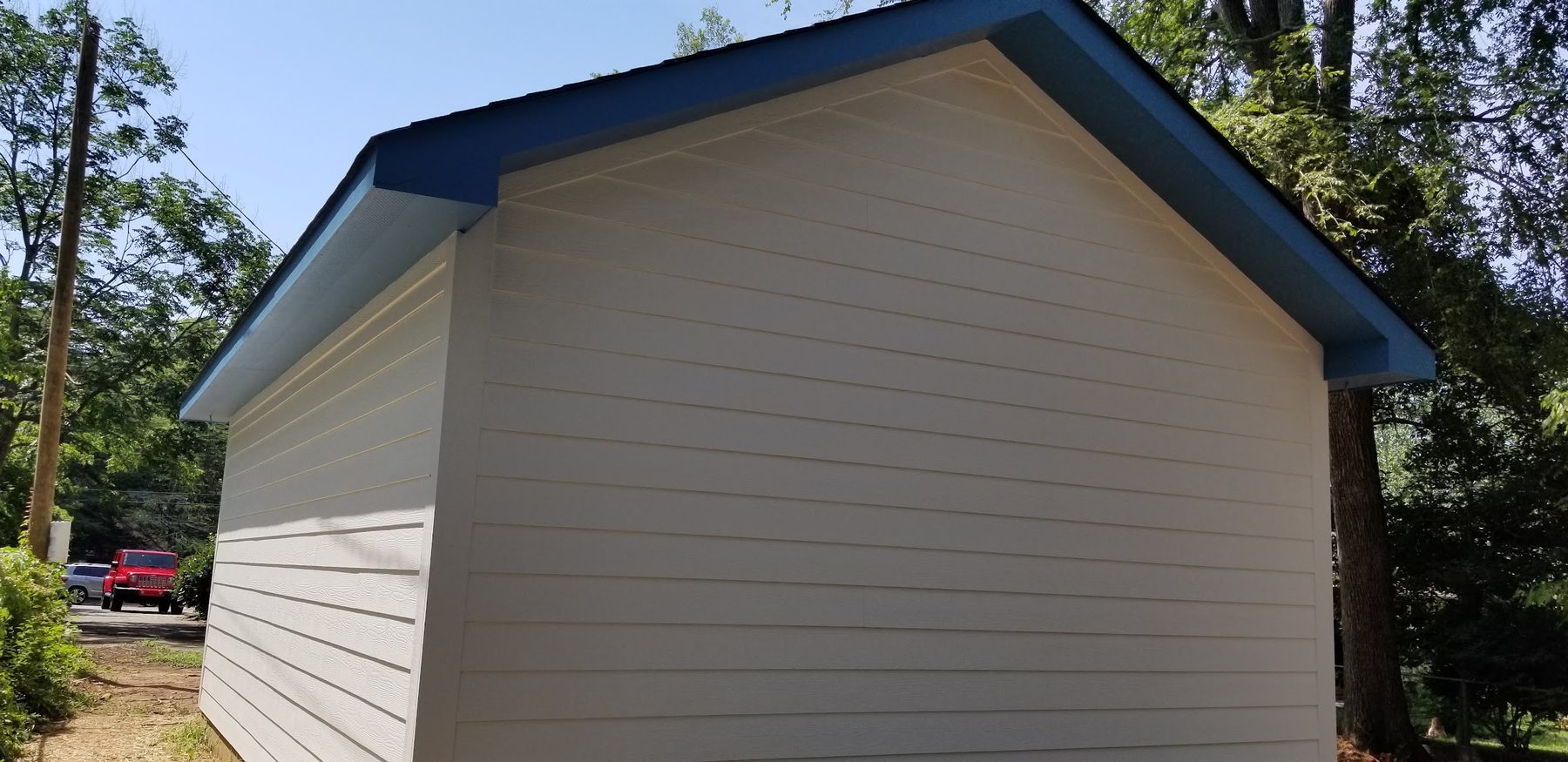 Finished detached garage with blue metal roof