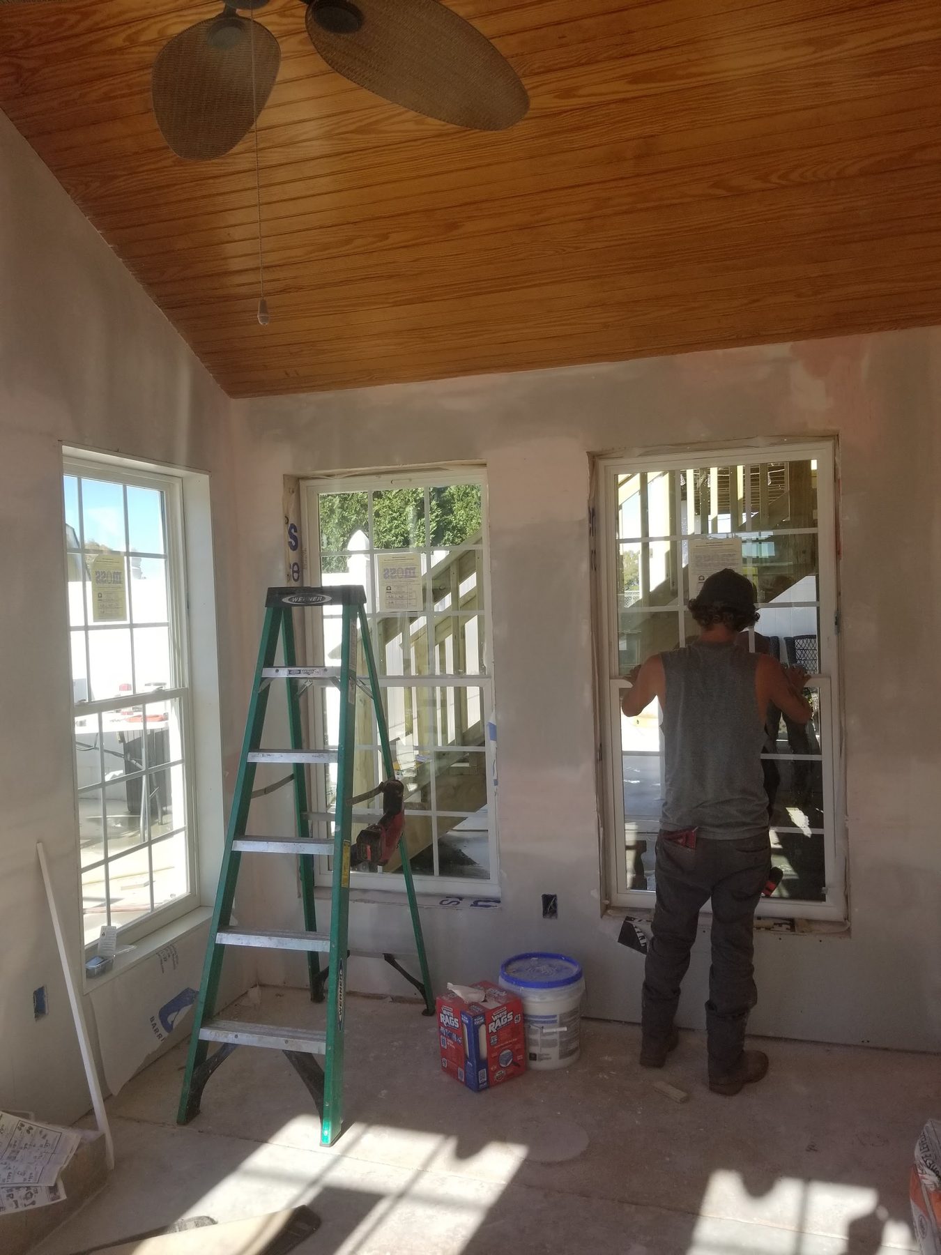 Crew finishing interior trim and paint on a Tessco build